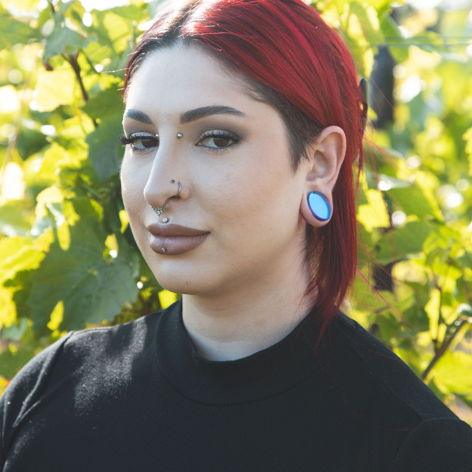 Model With Stretched Ears Wearing Glass Plugs