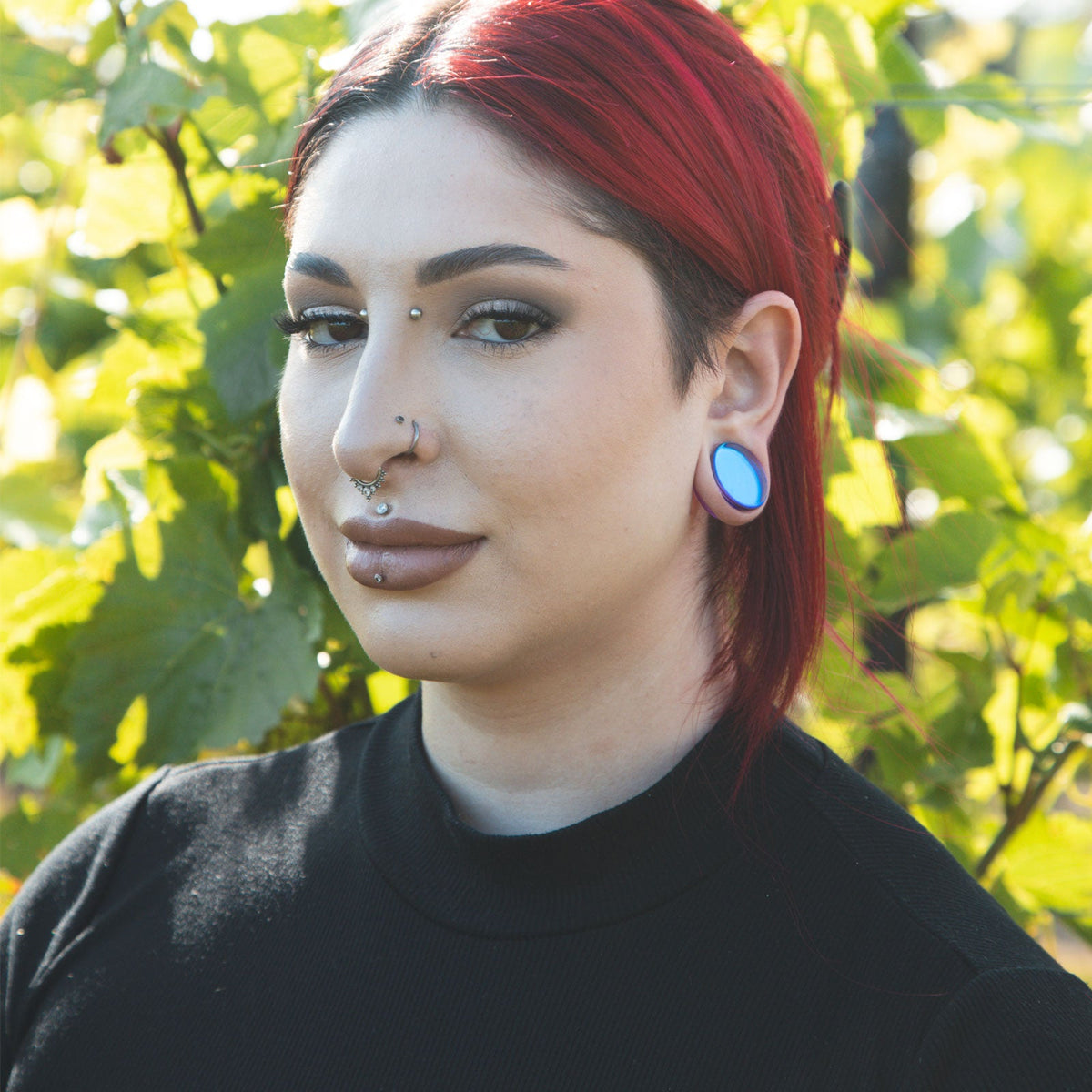 Model With Stretched Ears Wearing Glass Plugs