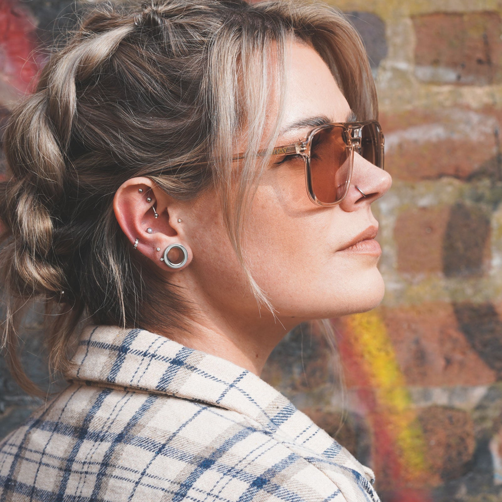 Model With Stretched Ears Wearing Steel Flesh Tunnels