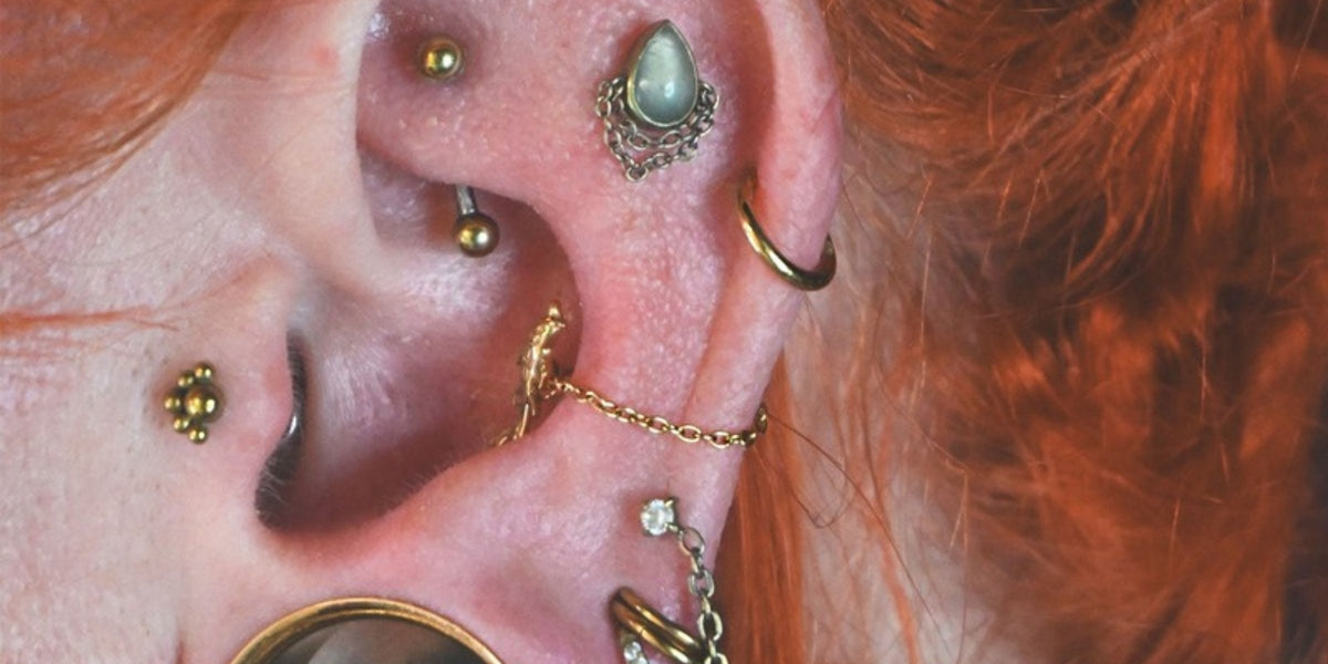 Helix piercing jewellery - gold hinged ring in a helix piercing