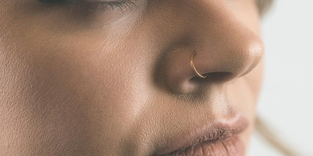 Gold nose rings - gold seamless nose ring in a nostril piercing