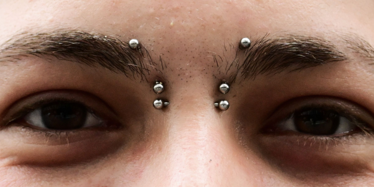 Bridge piercing jewellery - straight barbell across the bridge of the nose