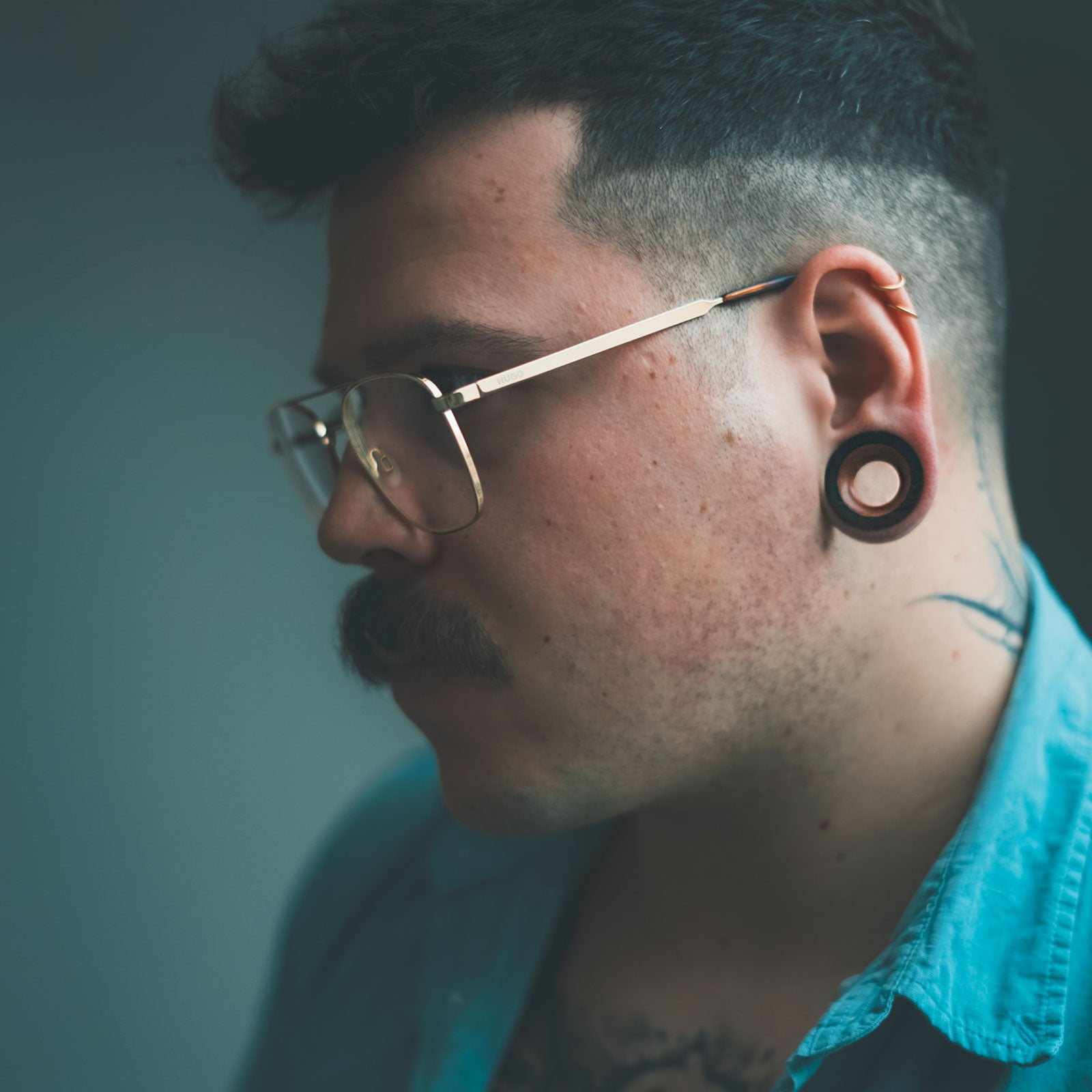 model wearing wooden flesh tunnels