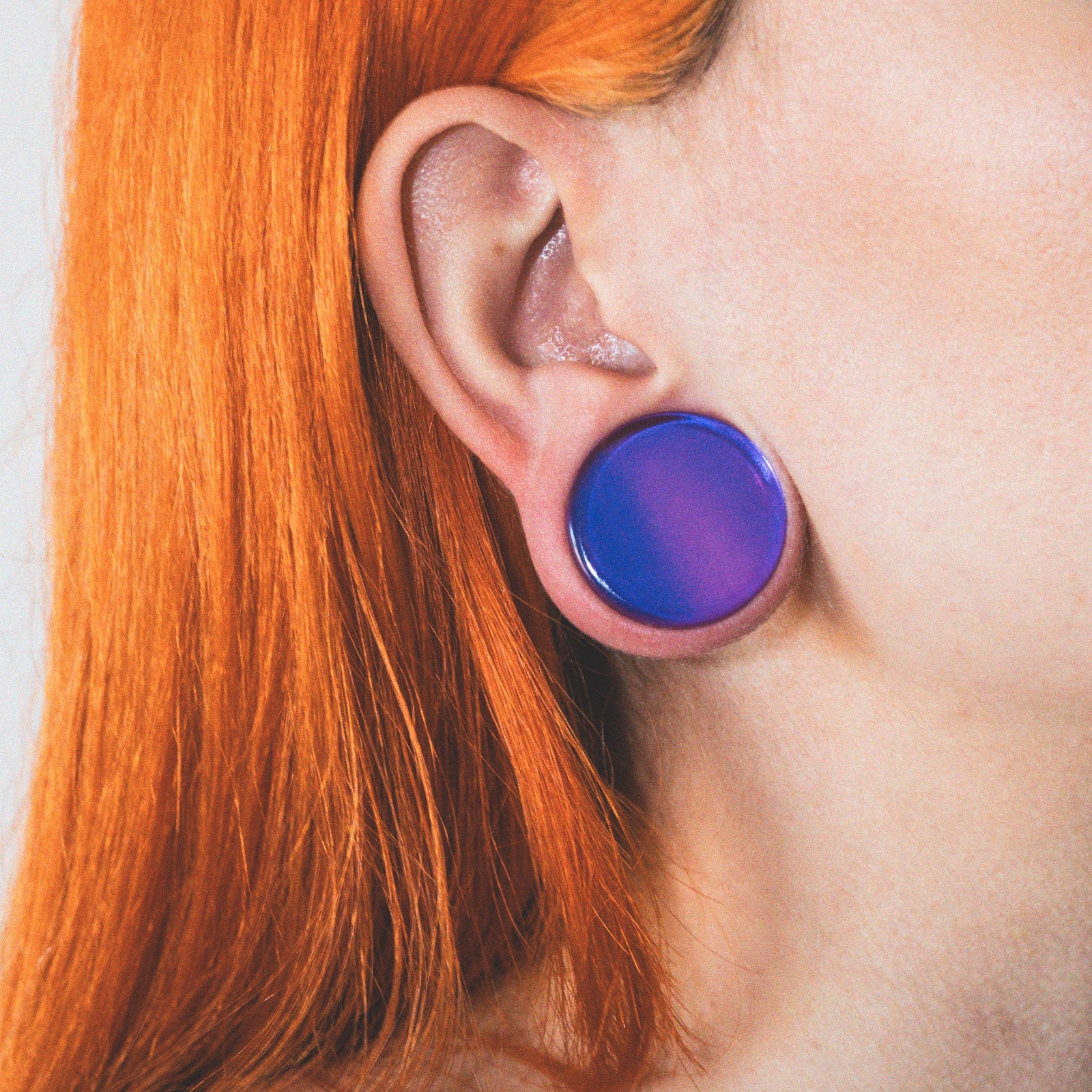 model wearing glass double flare plugs