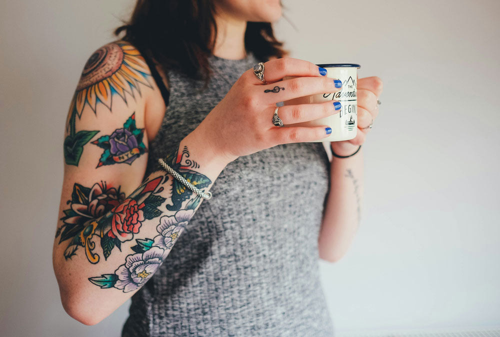 tattooed women drinking a cup of tea