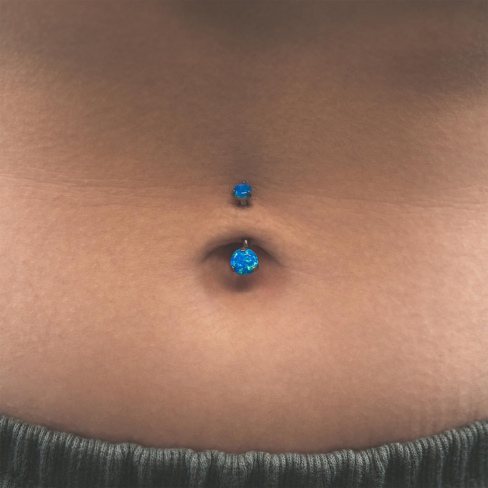Double Pacific Blue Synth Opal Internally Threaded Titanium Belly Bar Model Shot