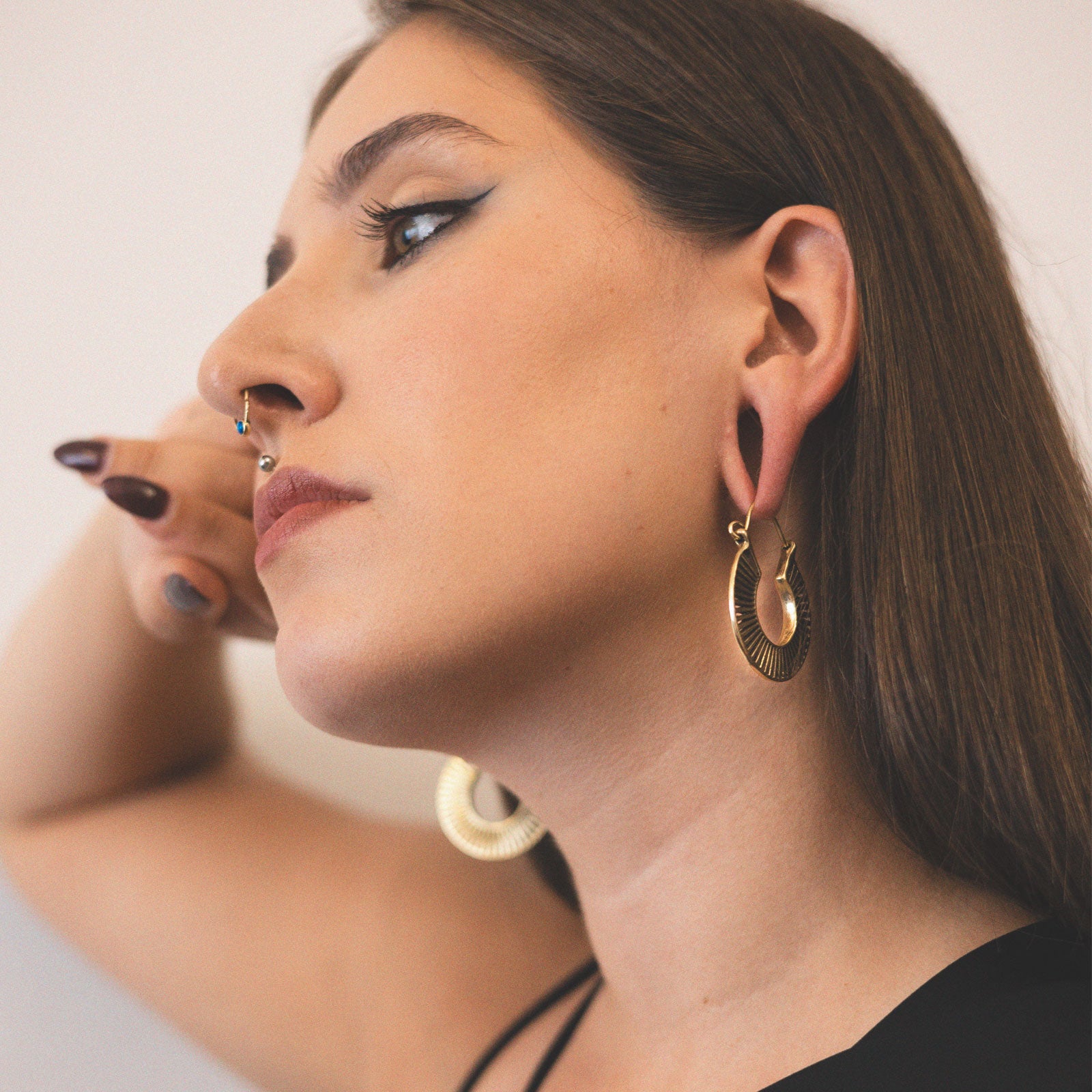 Golden Slinky Brass Plug Hoops Model Shot