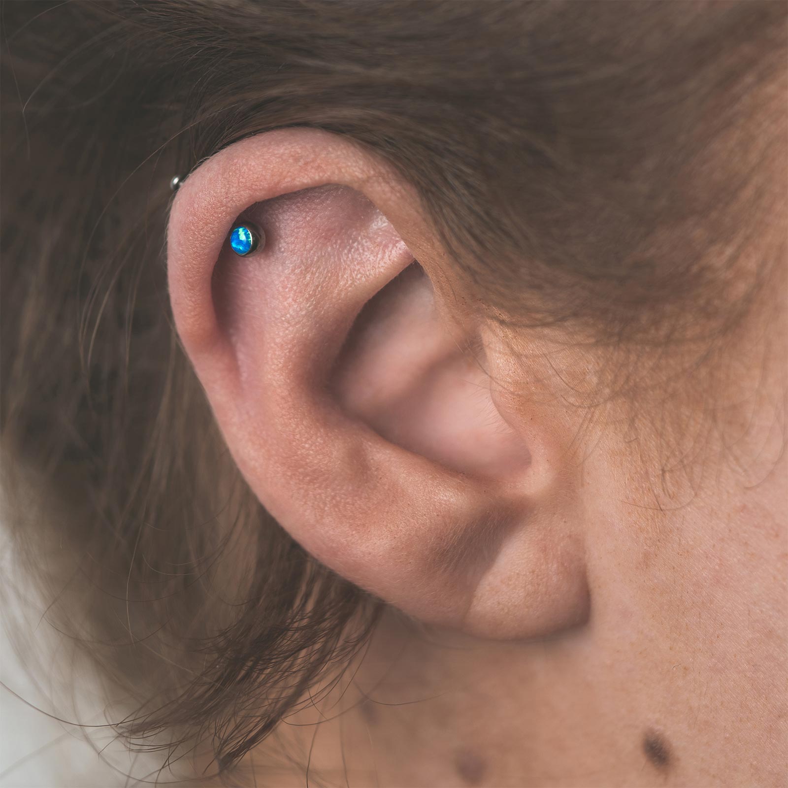 Pacific Blue Front Facing Synth Opal Titanium Threadless Top Model Shot