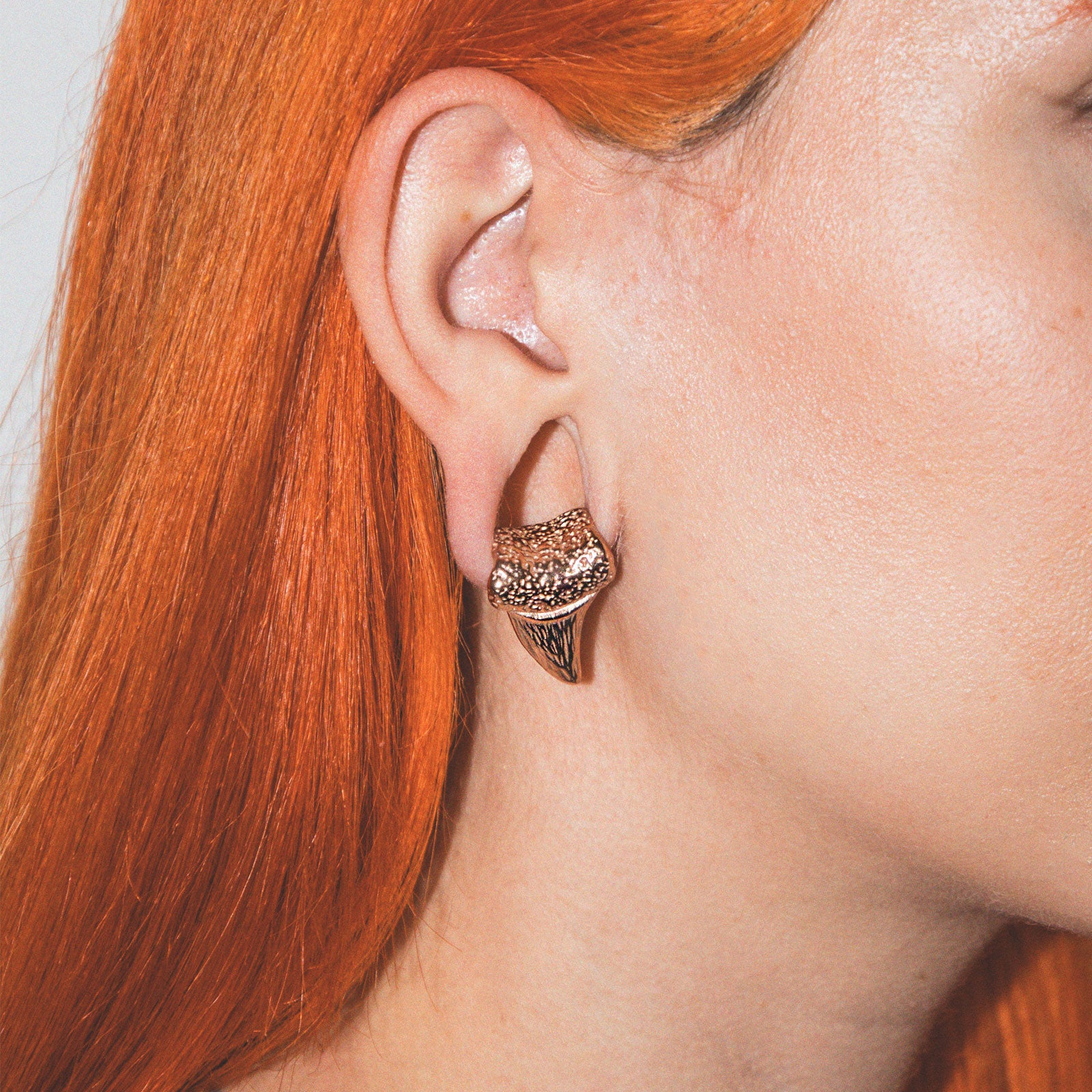 model wearing ear weights