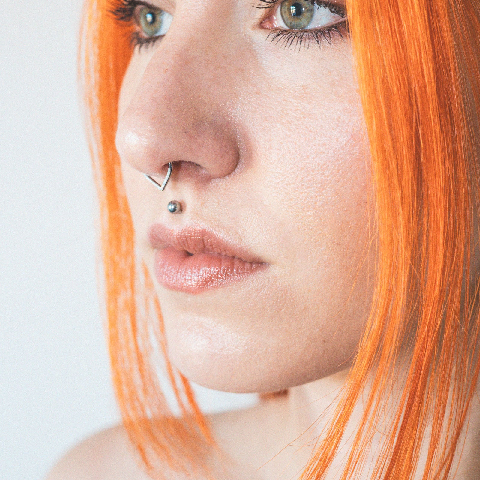 Teardrop Inlaid Fire & Snow Synth Opal Titanium Septum Clicker Model Shot