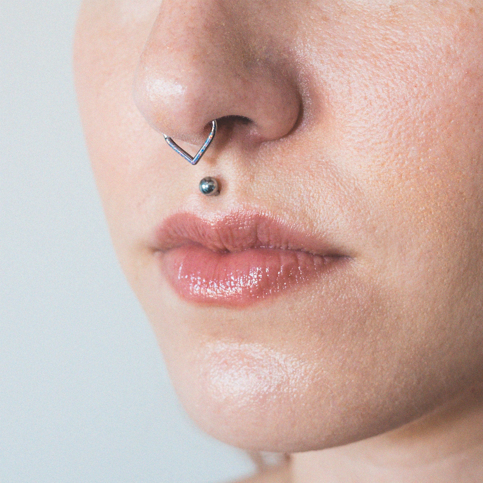 Teardrop Inlaid Flash Lavender Synth Opal Titanium Septum Clicker Model Shot