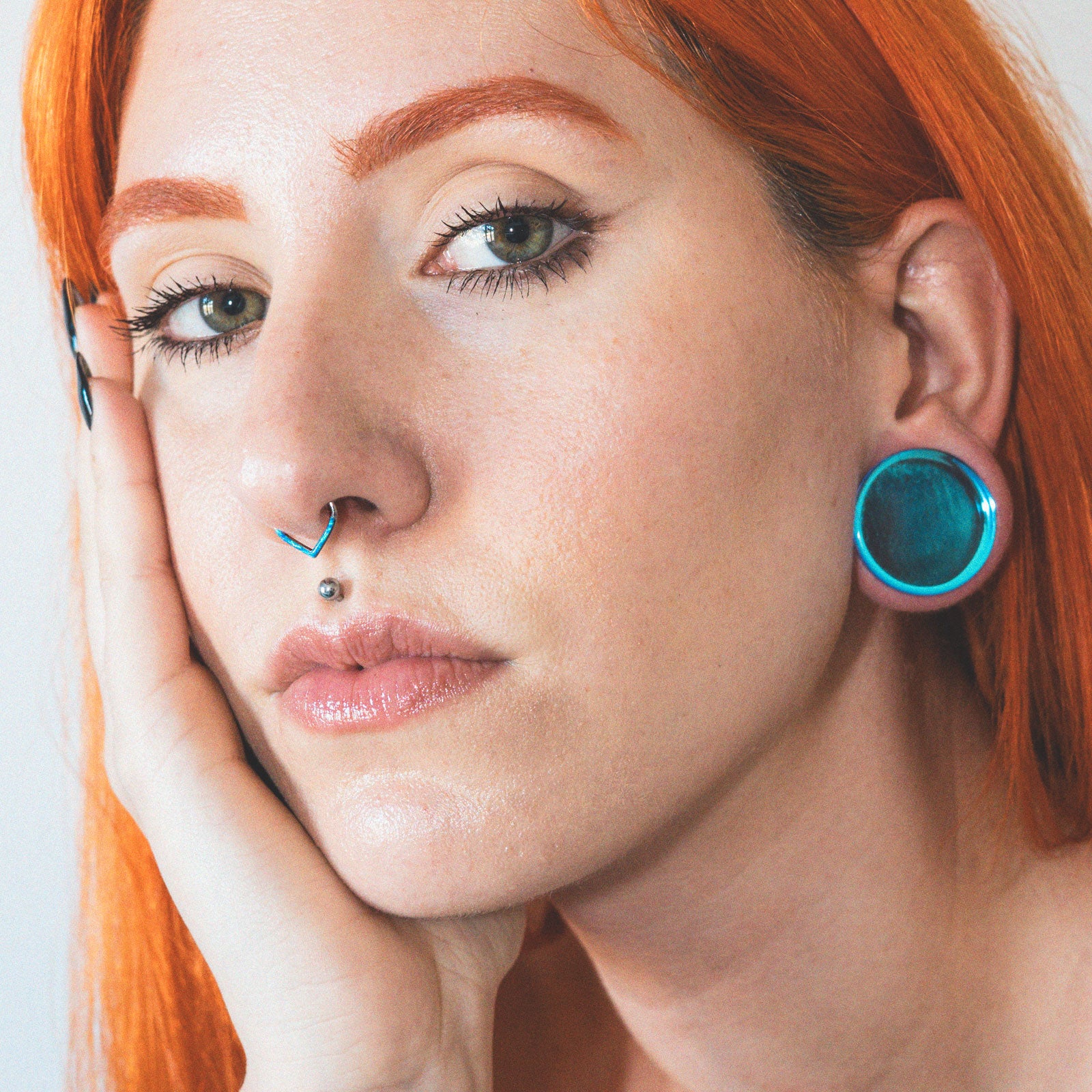 Teardrop Inlaid Pacific Blue Synth Opal Titanium Septum Clicker Model Shot