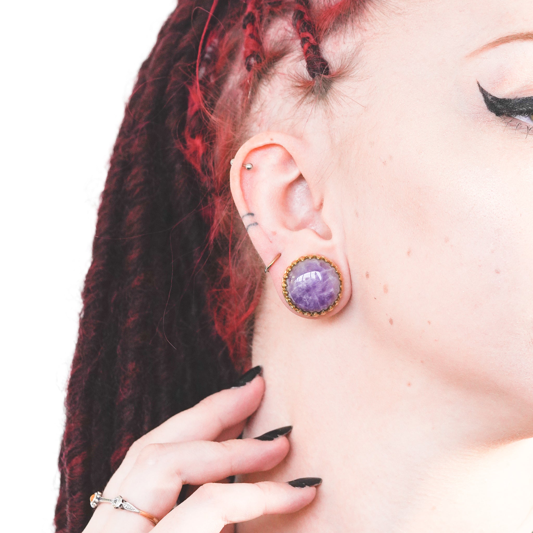 Model Wearing brass amethyst inlay plug in 20mm gauge