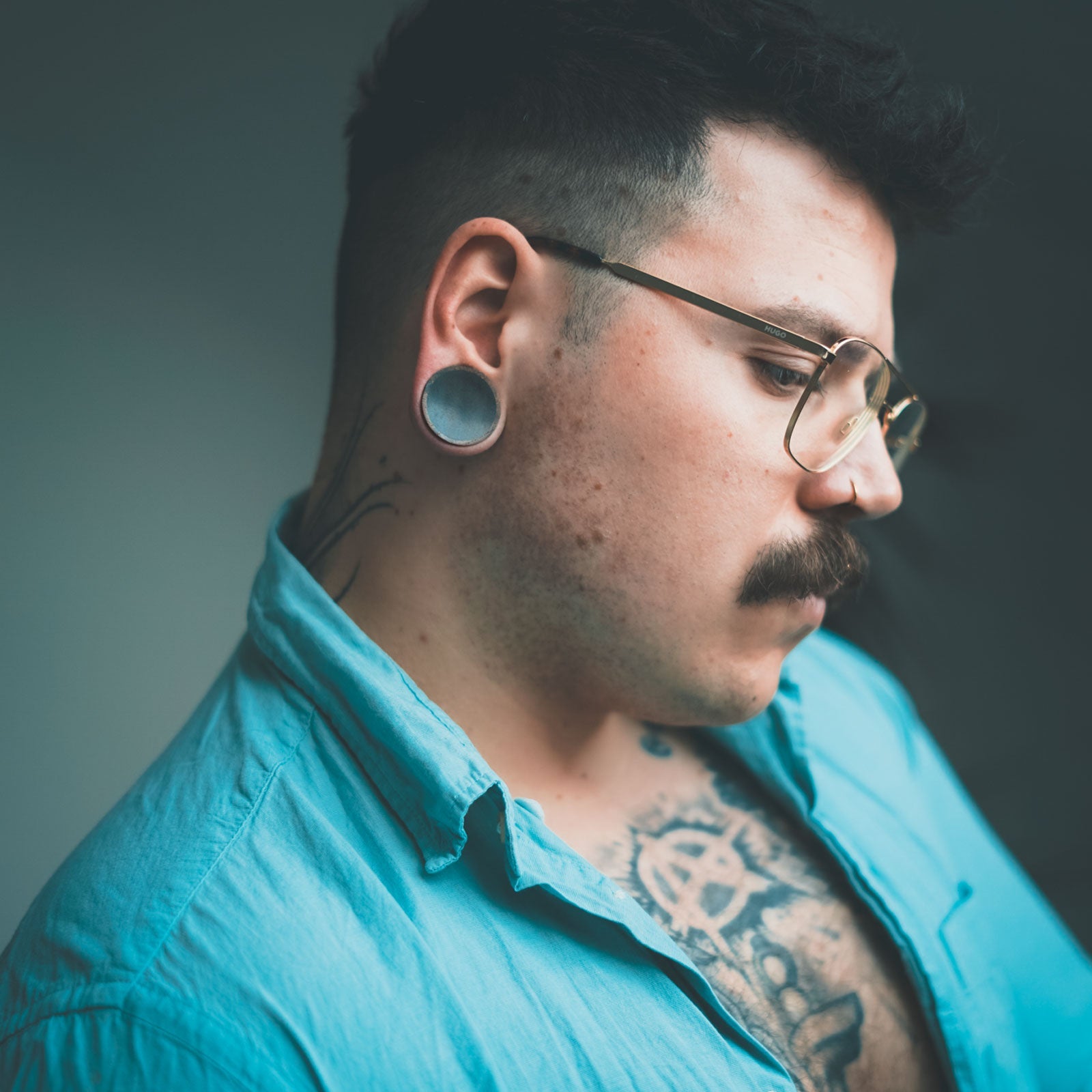 Model With Stretched Ears Wearing Wood Ear Plugs
