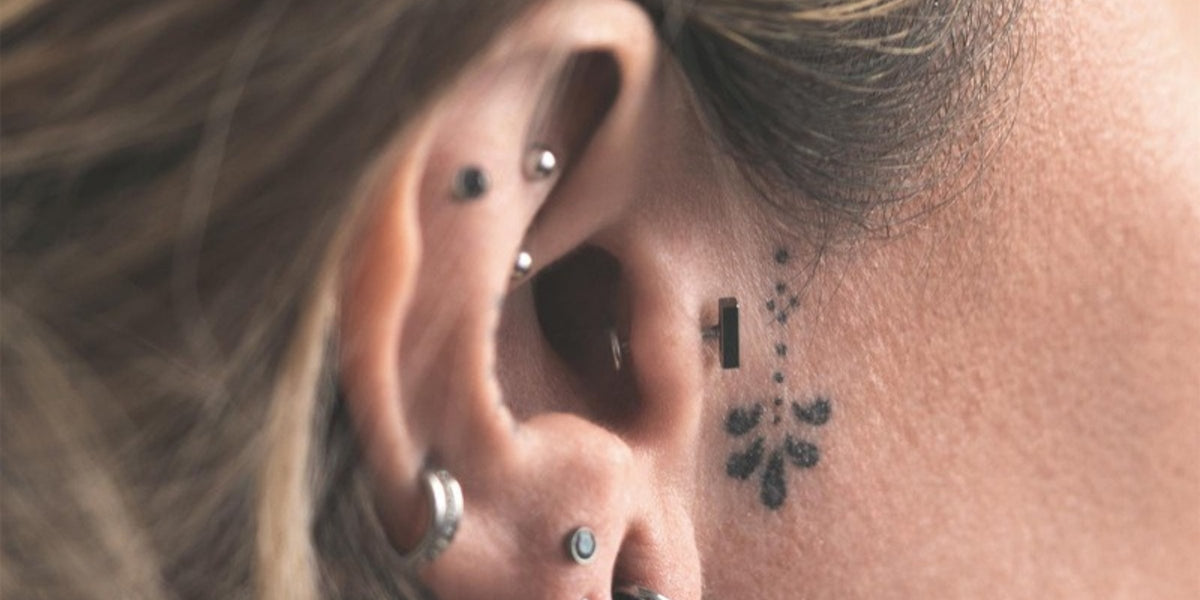 Cartilage piercing jewellery - titanium studs and rings across the ear